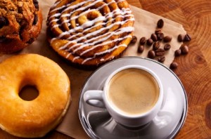Fresh doughnut and cookies with an espresso